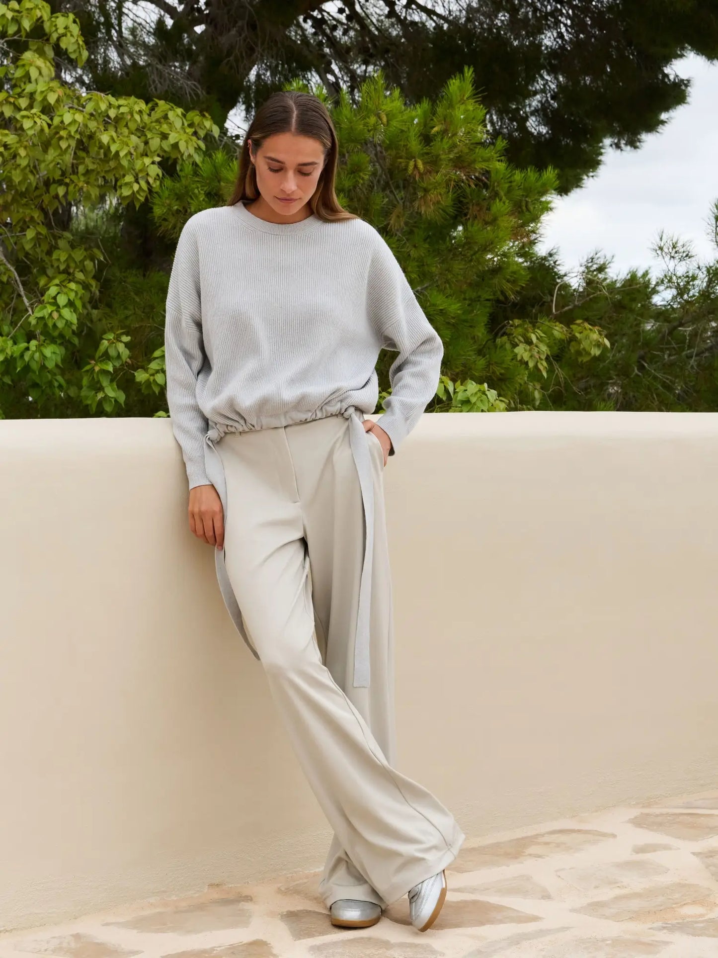 Knitted sweater with tie details at the hem