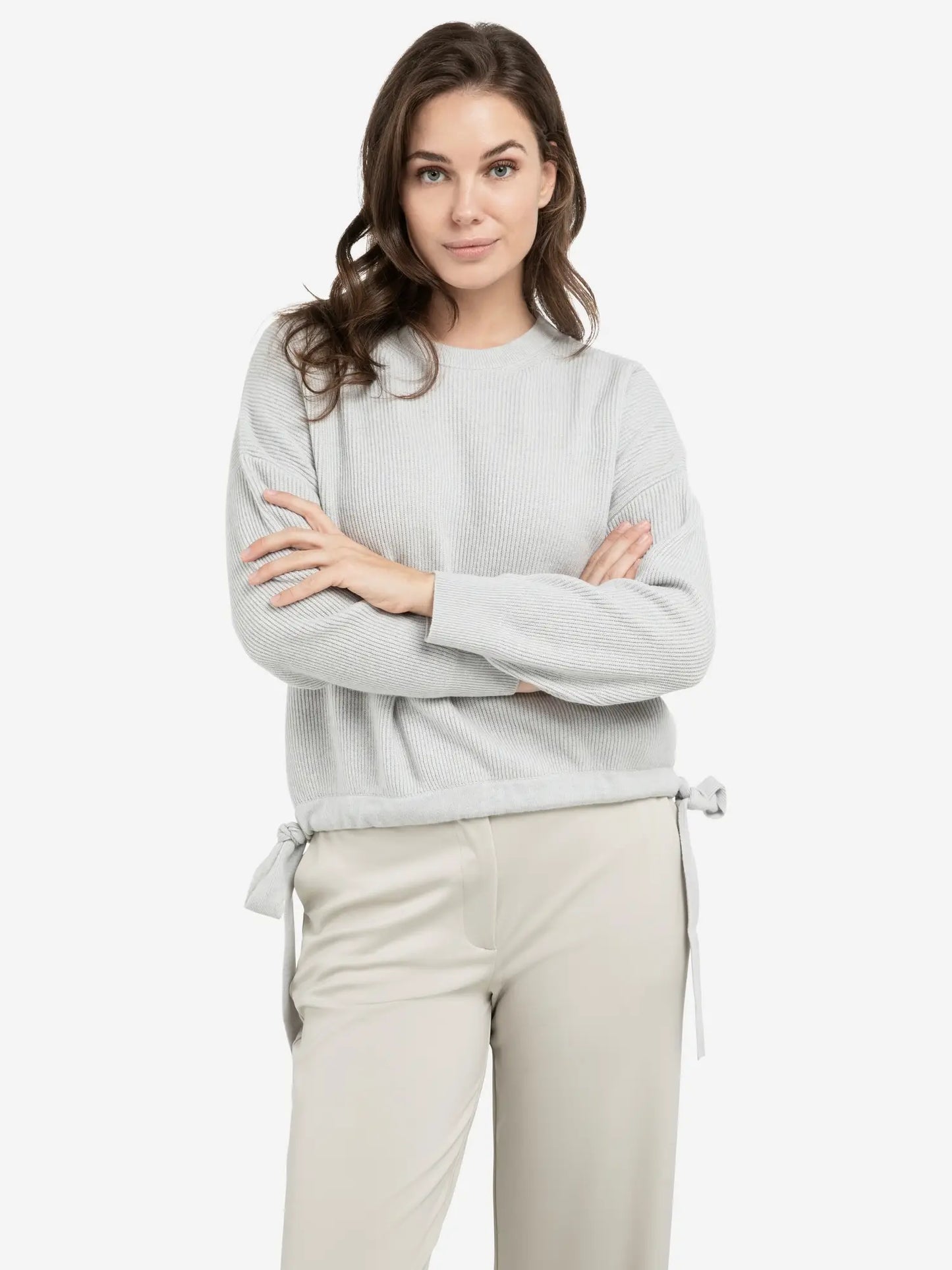 Knitted sweater with tie details at the hem